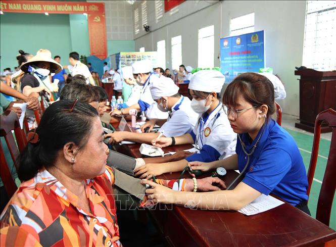 Tình nguyện viên Trường Cao đẳng Y tế An Giang khám bệnh cấp thuốc miễn phí cho đồng bào Khmer xã Định Hòa. Ảnh: Văn Sĩ - TTXVN
