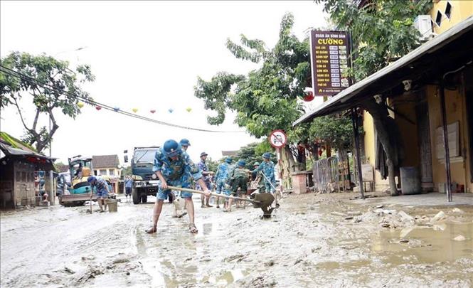 Lực lượng quân đội tham gia làm sạch môi trường phố cổ Hội An sau lũ. Ảnh: Trần Tĩnh -TTXVN