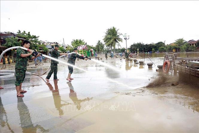 Lực lượng quân đội tham gia làm sạch môi trường phố cổ Hội An sau lũ. Ảnh: Trần Tĩnh -TTXVN