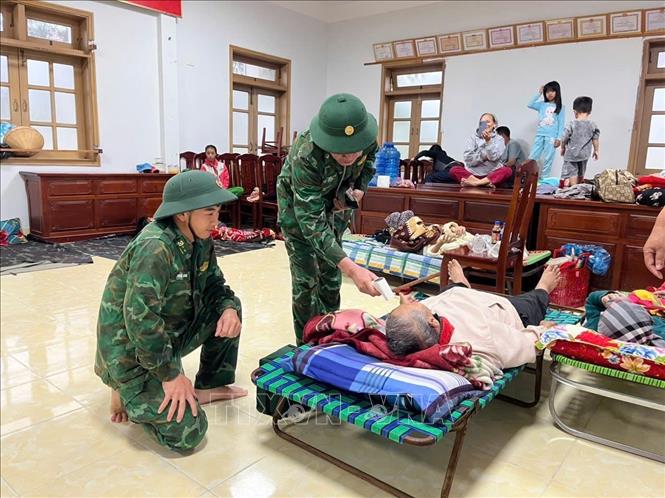 Cán bộ, chiến sĩ Đồn Biên phòng Xuân Hòa theo dõi sức khỏe người dân đang tránh trú bão. Ảnh: TTXVN phát