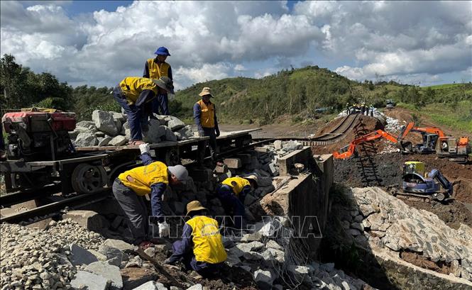 Các công nhân gia cố phần móng đường sắt. Ảnh: Tường Quân - TTXVN