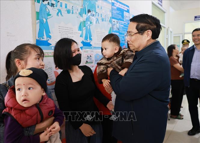 Thủ tướng Phạm Minh Chính với nhân dân đến khám, chữa bệnh tại trạm y tế xã Yên Khương. Ảnh: Dương Giang-TTXVN 
