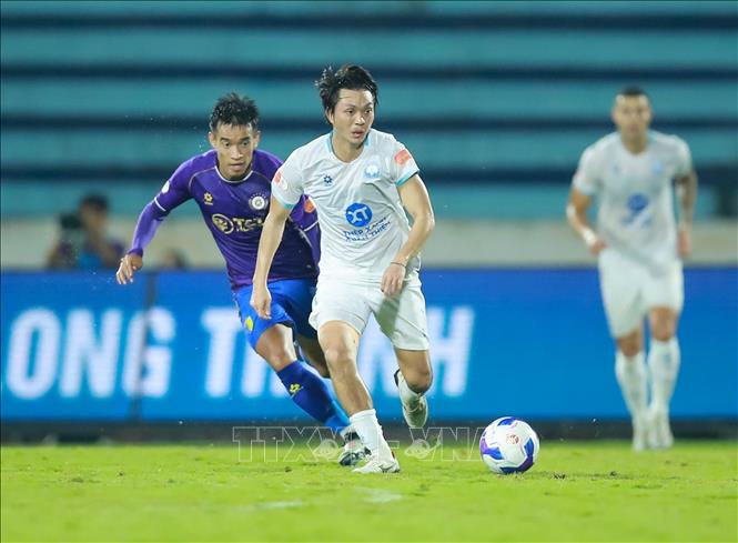 Tình huống tranh bóng giữa các cầu thủ Thép Xanh Nam Định (áo trắng) và Câu lạc bộ Hà Nội. Ảnh: Công Luật - TTXVN