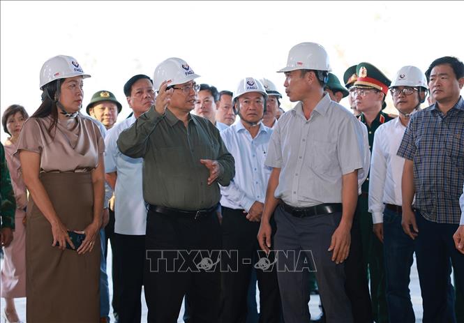 Thủ tướng Phạm Minh Chính thăm các cơ sở sản xuất bị thiệt hại do bão số 13 tại Khu kinh tế Nhơn Hội. Ảnh: Dương Giang-TTXVN 
