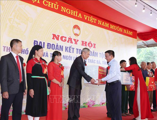Thường trực Ban Bí thư Trần Cẩm Tú tặng quà cho các gia đình tiêu biểu tại thôn Hồ Sen và thôn Ngòi Lẻn, xã Thác Bà. Ảnh: Phương Hoa - TTXVN