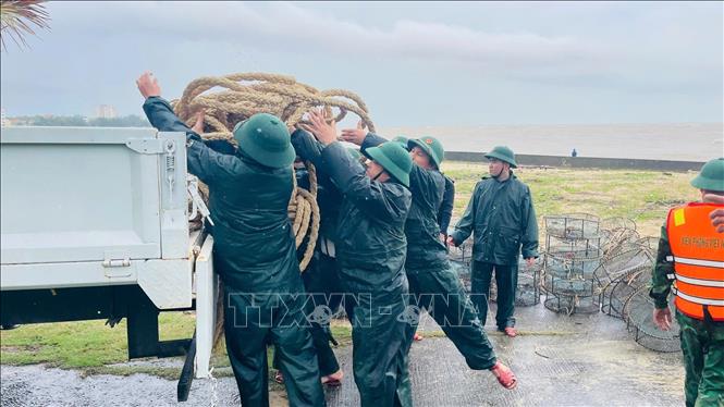 Đồn Biên phòng Nhật Lệ giúp ngư dân thu gom vật chất tàu cá bị chìm. Ảnh: TTXVN phát