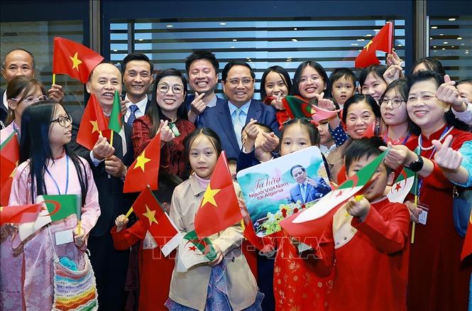 Prime Minister Pham Minh Chinh and his spouse pose for a group photo with staff of the Vietnamese Embassy and representatives of the Vietnamese community in Algeria. VNA Photo: Dương Giang