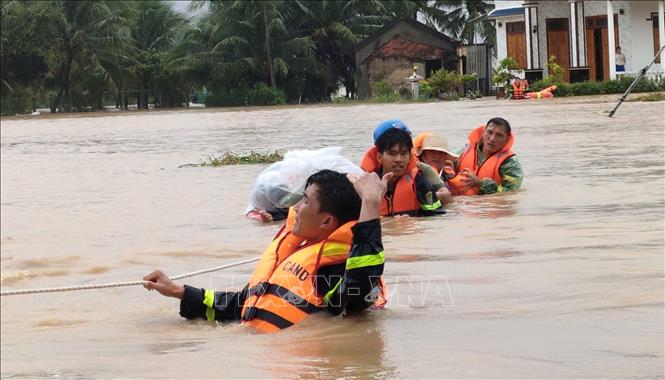 Lực lượng chức năng sơ tán người dân khu vực bị ngập lụt ở xã Hòa Trí (Khánh Hòa). Ảnh: TTXVN phát