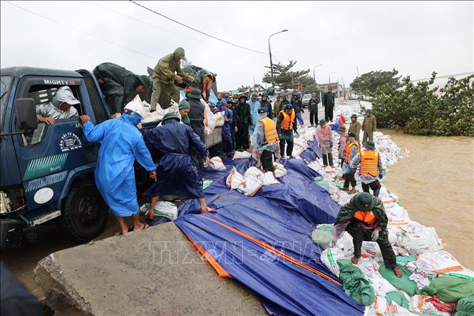 Hàng trăm cán bộ, chiến sĩ các lực lượng vũ trang cùng nhân dân địa phương đang khẩn trương gia cố bờ kè An Lương. Ảnh: Anh Dũng – TTXVN