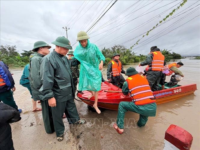 Lực lượng vũ trang tỉnh Gia Lai nỗ lực giúp dân di dời khỏi vùng ngập lụt. Ảnh: Sỹ Thắng - TTXVN 