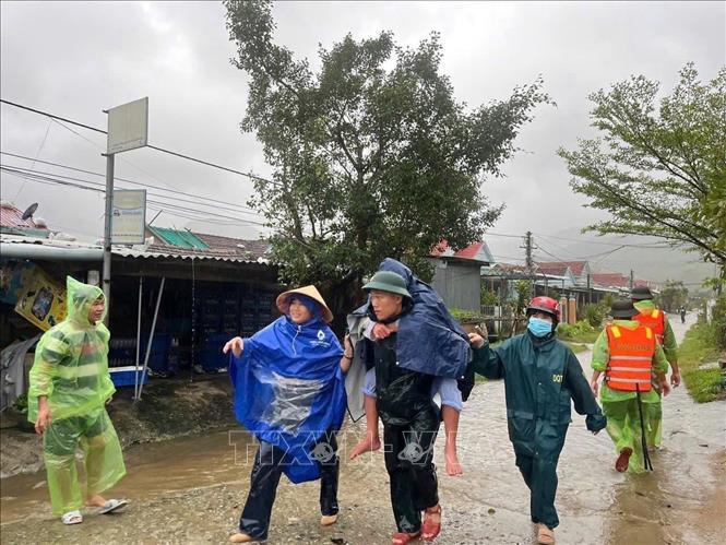  Bộ đội Biên phòng Gia Lai giúp dân sơ tán người già, trẻ em ra khỏi vùng lũ phường Hoài Nhơn Đông. Ảnh: TTXVN phát