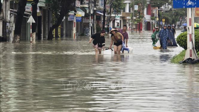 Người dân vượt trũng thấp sơ tán ra ngoài. Ảnh: Đặng Tuấn – TTXVN
