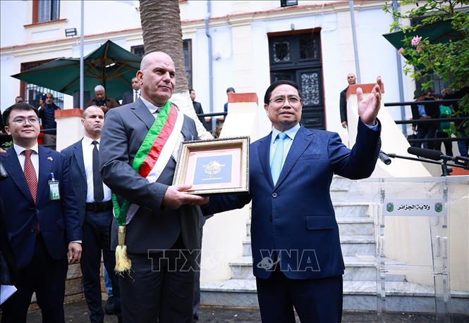 Thủ tướng Phạm Minh Chính tặng quà cho chính quyền địa phương, nơi đặt bia tưởng niệm về thân thế, sự nghiệp Chủ tịch Hồ Chí Minh ở Algeria. Ảnh: Dương Giang- TTXVN