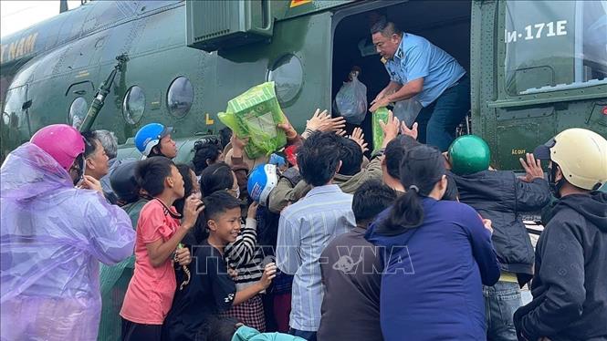 Người dân xã Phong Liên 1 và Phong Liên 2 nhận hàng cứu trợ từ trực thăng của Trung đoàn Không quân 917. Ảnh: TTXVN phát
