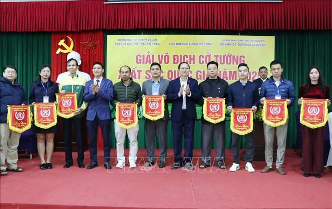 Ban tổ chức trao cờ lưu niệm cho các đoàn vận động viên tham gia giải. Ảnh: Trần Trang - TTXVN 