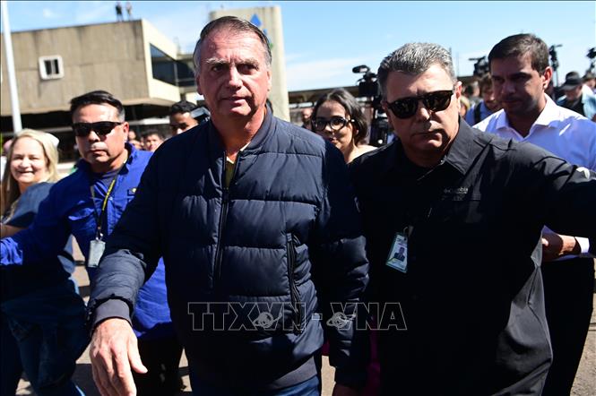 Cựu Tổng thống Brazil Jair Bolsonaro (trái, trước) rời trụ sở Cảnh sát hình sự ở Brasilia ngày 18/7/2025. Ảnh: THX/TTXVN