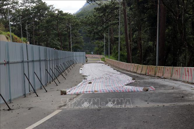 Một vị trí mặt đường bị nứt đang được đơn vị thi công xử lý. Ảnh: Chu Quốc Hùng- TTXVN