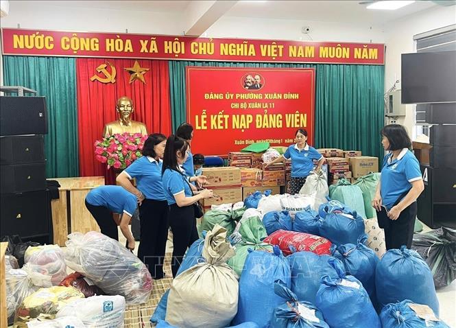 Volunteers in Hanoi pack essential goods to people suffering from heavy floods in Central region. VNA Photo: Quốc Lũy