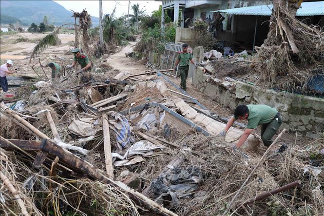 Các chiến sỹ Trường Cao đẳng An ninh nhân dân 1 (Bộ Công an) giúp dọn dẹp bùn đất tại các trường học, trụ sở tại xã Đồng Xuân. Ảnh: Xuân Quý – TTXVN
