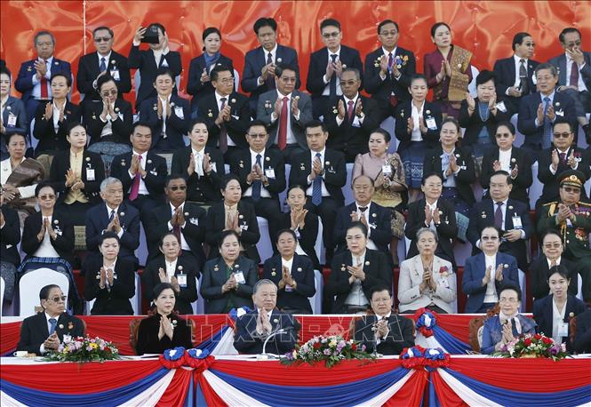 Party General Secretary To Lam, his spouse and delegates attend the ceremony to celebrate the 50th anniversary of the National Day of the Lao People's Democratic Republic. VNA Photo: Thống Nhất