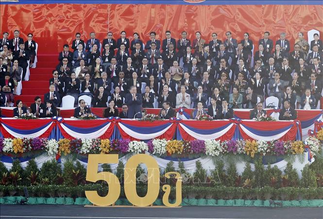 Party General Secretary To Lam, his spouse and delegates attend the ceremony to celebrate the 50th anniversary of the National Day of the Lao People's Democratic Republic. VNA Photo: Thống Nhất
