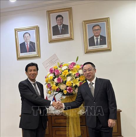 Đại sứ Việt Nam tại Indonesia Tạ Văn Thông chúc mừng Đại sứ Lào tại Indonesia Khamfeuang Phanthaxay. Ảnh: Đỗ Quyên – PV TTXVN tại Indonesia