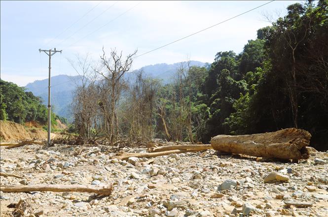 Khu vực trung tâm bản Phá Mựt hiện chỉ còn khung cảnh ngổn ngang đá, thân cây và rác. Ảnh: Xuân Tiến - TTXVN 