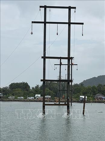 Công ty Điện lực An Giang thi công đường dây 110kV trên không với 4 khoảng trụ khắc phục sự cố cáp ngầm 110kV Hà Tiên - Phú Quốc. Ảnh: TTXVN phát