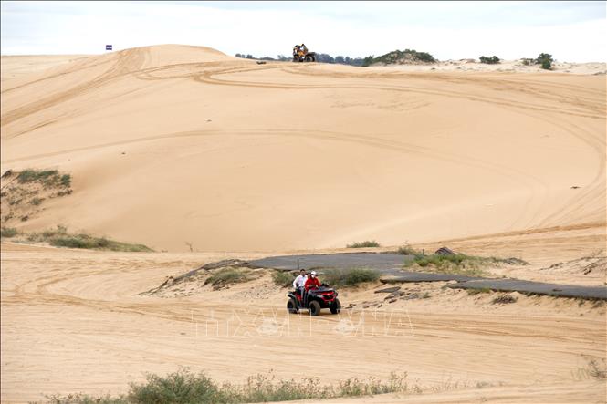 Tourists riding ATVs at Bau Trang Scenic Site, within the Mui Ne National Tourist Area plan. VNA Photo: Nguyễn Thanh 