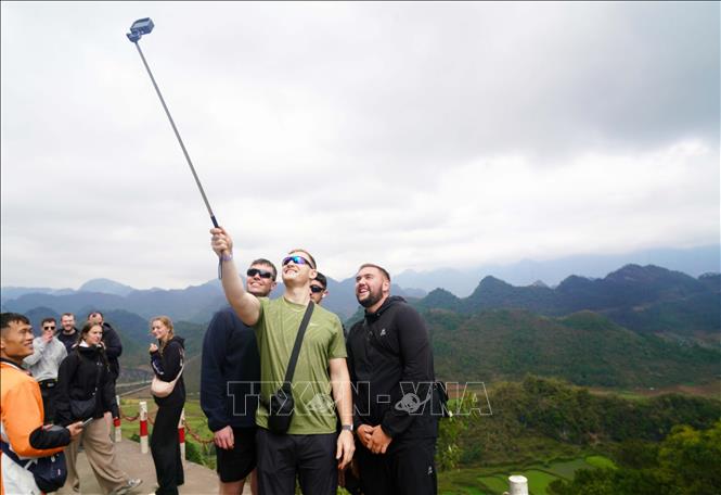 Du khách thích thú lưu lại khoảnh khắc tại Cao nguyên đá Đồng Văn. Ảnh: Khánh Hoà - TTXVN 