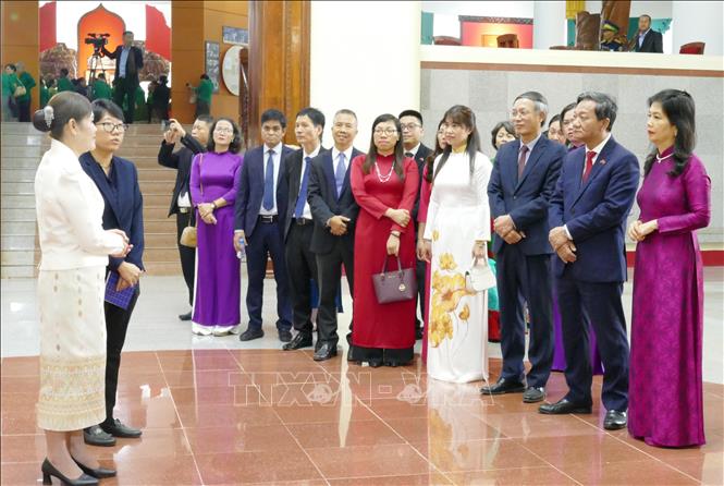 Đoàn đại biểu Đại sứ quán Việt Nam tại Lào lắng nghe hướng dẫn viên kể về cuộc đời, thân thế và sự nghiệp Chủ tịch Kaysone Phomvihane. Ảnh: Xuân Tú - PV TTXVN tại Lào