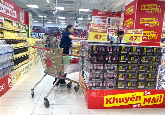 Sức tiêu dùng tăng mạnh, nhân viên liên tục đưa hàng lên quầy kệ.  Ảnh: Hương Giang - TTXVN