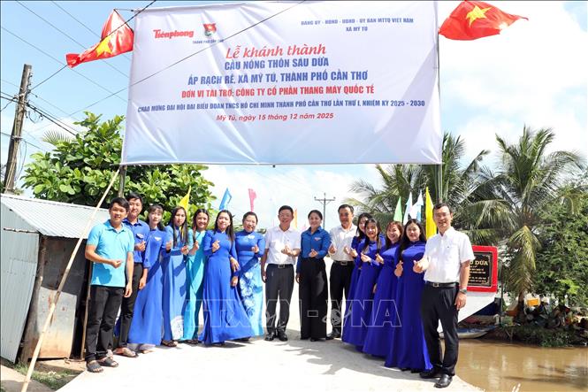 Đại biểu và chính quyền địa phương chụp hình lưu niệm cùng cầu nông thôn Sáu Dừa tại lễ khánh thành. Ảnh: Trung Kiên - TTXVN