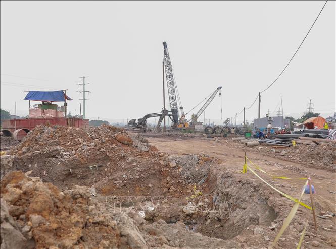 Sở Xây dựng siết giám sát, yêu cầu mọi công trường che chắn, phun giảm bụi, rửa xe ra vào, phế thải xây dựng phải che kín, tránh phát tán ra môi trường. Ảnh: Phan Phương – TTXVN