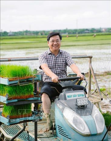 Anh Hồ Xuân Hiếu bên chiếc máy cấy lúa hiện đại ứng dụng trong sản xuất lúa hữu cơ theo tiêu chuẩn USDA (Mỹ) và EU (châu Âu) triển khai trên toàn tỉnh. Ảnh: TTXVN phát
