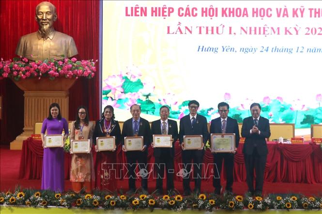 Trao Kỷ niệm chương của Liên hiệp các Hội Khoa học và Kỹ thuật Việt Nam cho các đại biểu. Ảnh: Đinh Văn Nhiều-TTXVN