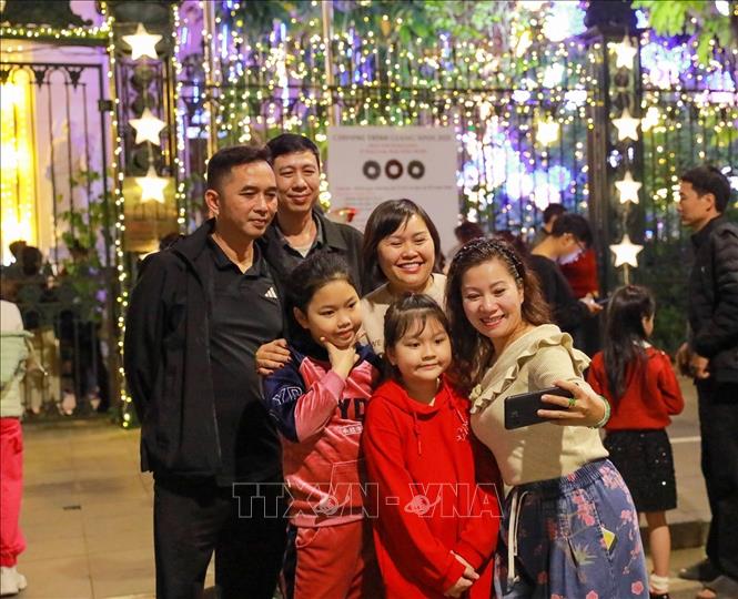 Người dân và du khách đón Giáng sinh tại Nhà thờ Hàm Long, phường Hai Bà Trưng. Ảnh: Khánh Hoà - TTXVN