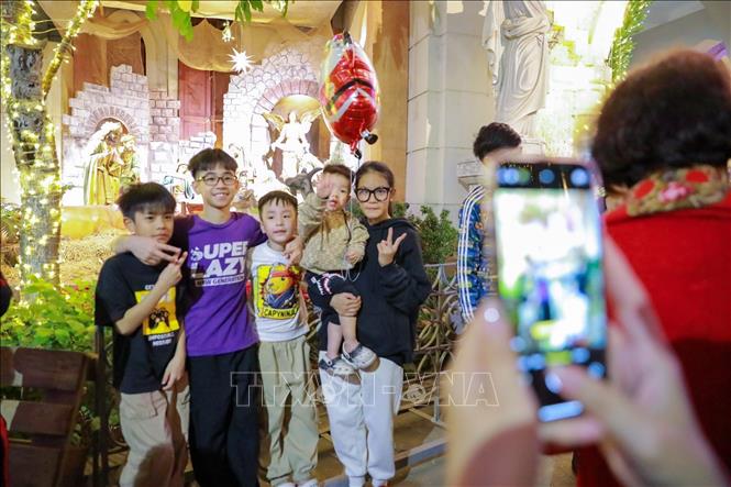 Người dân và du khách đón Giáng sinh tại Nhà thờ Hàm Long, phường Hai Bà Trưng. Ảnh: Khánh Hoà - TTXVN