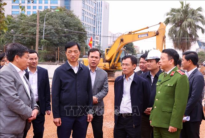 Bí thư Thành uỷ Hà Nội Nguyễn Duy Ngọc kiểm tra tiến độ thi công đã cam kết, công tác giải phóng mặt bằng tuyến đường Vành đai 1 đoạn Hoàng Cầu-Voi Phục. Ảnh: Văn Điệp – TTXVN