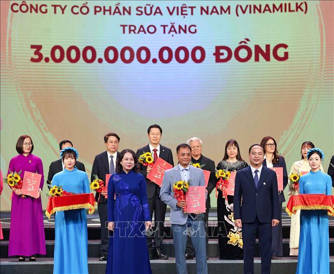 Phó Chủ tịch nước, Chủ tịch Hội đồng Bảo trợ Quỹ Bảo trợ trẻ em Việt Nam Võ Thị Ánh Xuân cùng Giám đốc Quỹ Bảo trợ trẻ em Việt Nam Đinh Tiến Hải trao giấy ghi nhận và tặng hoa các nhà tài trợ. Ảnh: Thanh Tùng - TTXVN