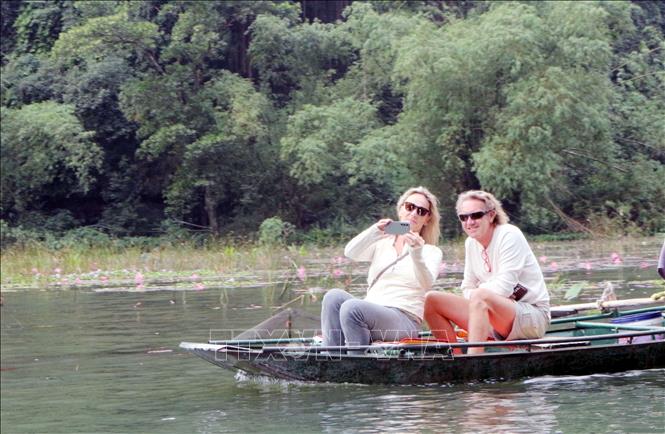 Foreign tourists check in at Tam Coc Tourism Site in the northern province of Ninh Binh. VNA Photo