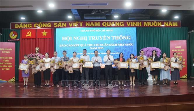 Bí thư Thành ủy TP. Hồ Chí Minh Trần Lưu Quang và Chủ tịch UBND thành phố Nguyễn Văn Được trao bằng khen cho các doanh nghiệp nộp ngân sách trên 3.000 tỷ đồng. Ảnh: Hứa Chung-TTXVN                     