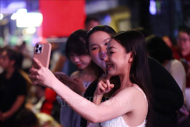 Các bạn trẻ cùng nhau lưu lại khoảnh khắc đẹp ngày cuối năm. Ảnh: Thu Hương - TTXVN