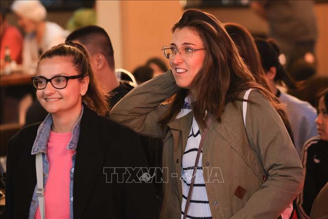 Niềm vui của du khách khi hoà mình vào không khí chờ đón năm mới 2026 tại khu vực phố cổ quanh hồ Hoàn Kiếm. Ảnh: Hoàng Hiếu - TTXVN