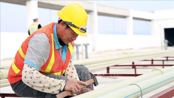 Công nhân đang lắp đặt hệ thống dẫn nước tại Công trình Bệnh viện Đa khoa tỉnh Tuyên Quang.  Ảnh: Hoàng Hải - TTXVN