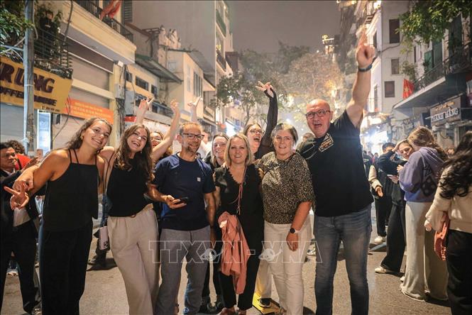 Foreign tourists celebrate New Year in Hanoi. VNA Photo