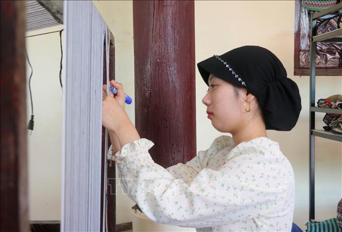 Ro Phi Ah (sinh năm 2009) là đời thứ 4 gắn bó với nghề dệt thổ cẩm ở làng Chăm Châu Phong, tỉnh An Giang. Ảnh: Công Mạo-TTXVN