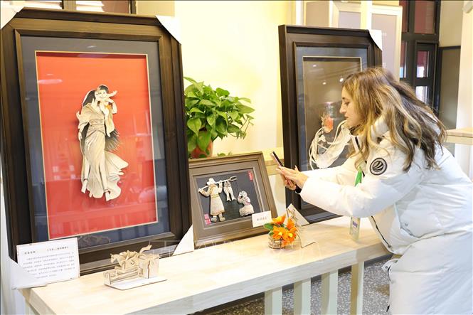 Du khách tìm hiểu về nghệ thuật chế tác tranh da cá của tỉnh Cát Lâm. Ảnh: Công Tuyên-PV TTXVN tại Trung Quốc