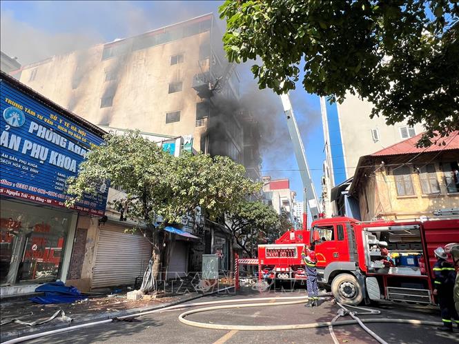 Lực lượng chức năng đang nỗ lực dập tắt đám cháy (ảnh chụp lúc 10h30). Ảnh: Thành Phương - TTXVN