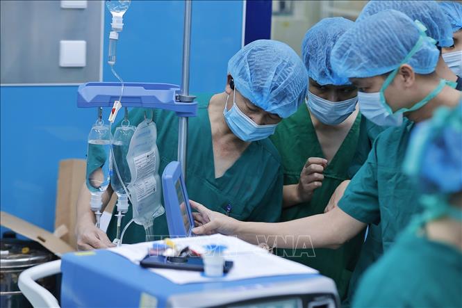 Ê kíp tiến hành đặt ECMO (hệ thống tim phổi nhân tạo), chuẩn bị ghép phổi cho bệnh nhân. Ảnh: Minh Quyết - TTXVN